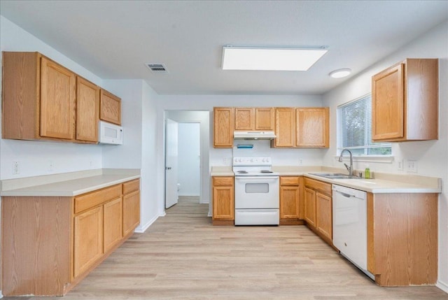 618 Lavaca Loop, Elgin, TX 78621 - kitchen featuring white appliances, under cabinet range hood, light wood-style floors, and light countertops