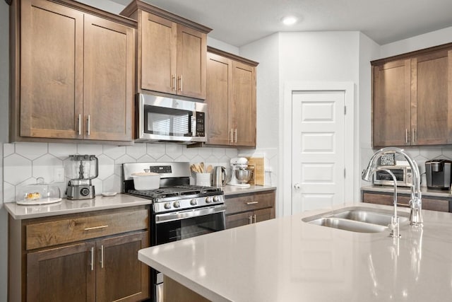 2705 Grizzly Way, Leander, TX 78641 - kitchen featuring stainless steel appliances, light countertops, backsplash, and recessed lighting
