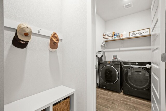 2705 Grizzly Way, Leander, TX 78641 - laundry room featuring washer and clothes dryer and wood finished floors