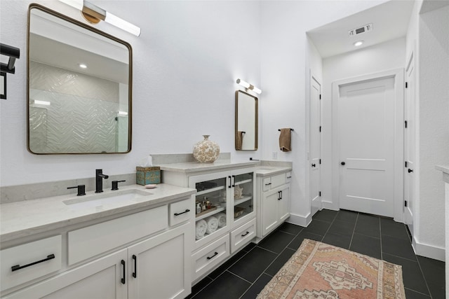 1122 Silver Dollar Trl, Georgetown, TX 78628 - bathroom featuring vanity, tile patterned flooring, and a tile shower