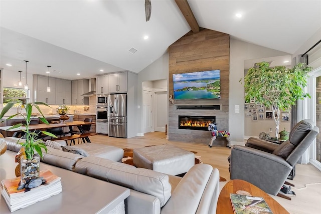 106 Samantha Ln, Kingsland, TX 78639 - living room with beam ceiling, high vaulted ceiling, a fireplace, recessed lighting, and light wood-style flooring
