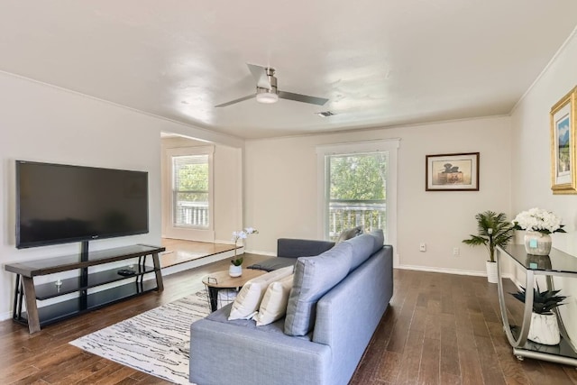 1202 Loma Dr, Austin, TX 78741 - living area with dark wood-type flooring, crown molding, plenty of natural light, and ceiling fan