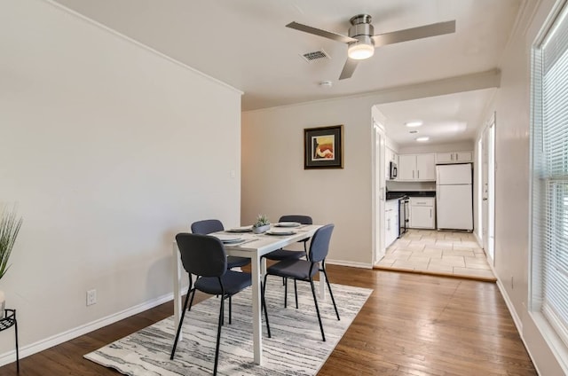 1202 Loma Dr, Austin, TX 78741 - dining area featuring ceiling fan, light wood-style floors, and ornamental molding