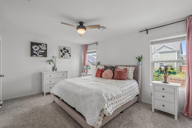 245 Red Buckeye Loop, Liberty Hill, TX 78642 - bedroom featuring light colored carpet, multiple windows, and a ceiling fan