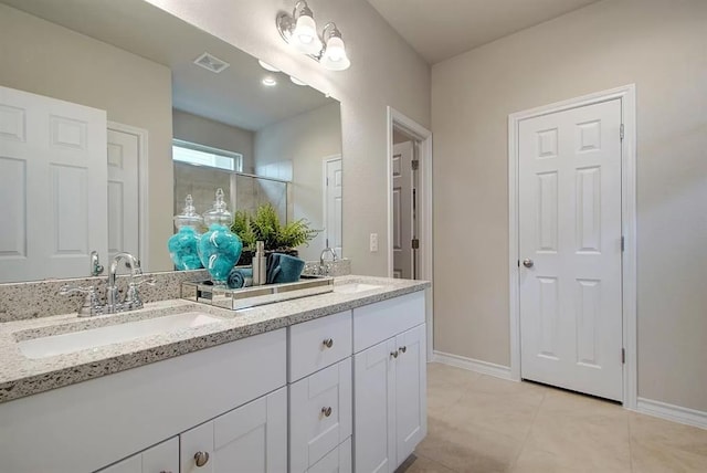 7634 Leonardo Dr, Round Rock, TX 78665 - bathroom with double vanity, tile patterned floors, and a shower with shower door