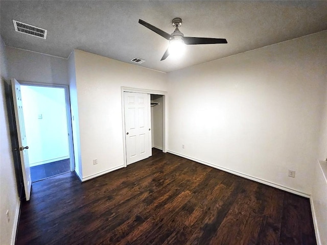 7634 Leonardo Dr, Round Rock, TX 78665 - unfurnished bedroom featuring dark wood finished floors, a ceiling fan, and a closet