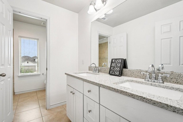 7634 Leonardo Dr, Round Rock, TX 78665 - full bath with double vanity and tile patterned floors