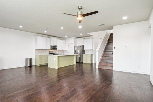 7634 Leonardo Dr, Round Rock, TX 78665 - unfurnished living room featuring a ceiling fan, dark wood finished floors, stairway, and recessed lighting