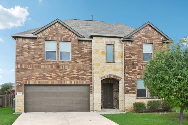 7634 Leonardo Dr, Round Rock, TX 78665 - view of front of house featuring an attached garage, stone siding, driveway, and roof with shingles