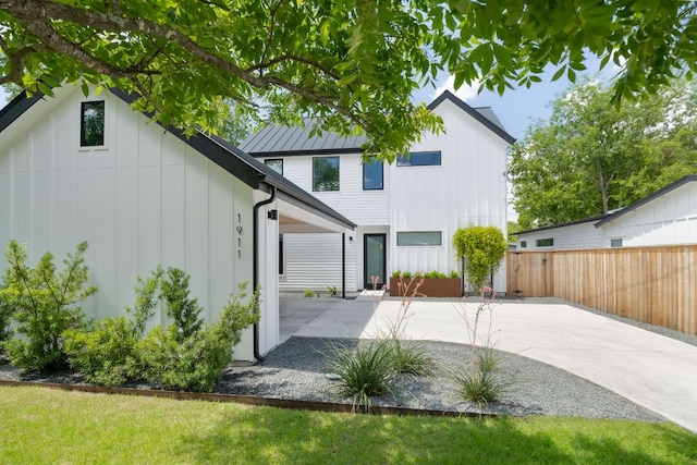 1911 Piedmont Ave, Austin, TX 78757 - rear view of house featuring a patio and board and batten siding