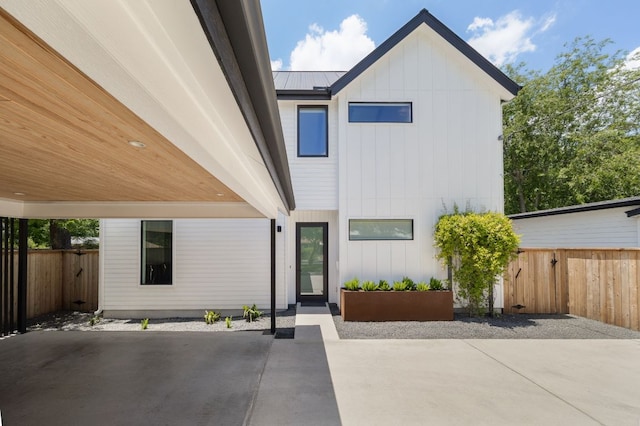 1911 Piedmont Ave, Austin, TX 78757 - view of front of home with a patio area, board and batten siding, and a metal roof