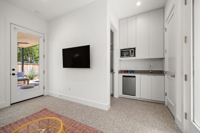 1911 Piedmont Ave, Austin, TX 78757 - kitchen featuring stainless steel microwave, white cabinets, dishwasher, and light colored carpet