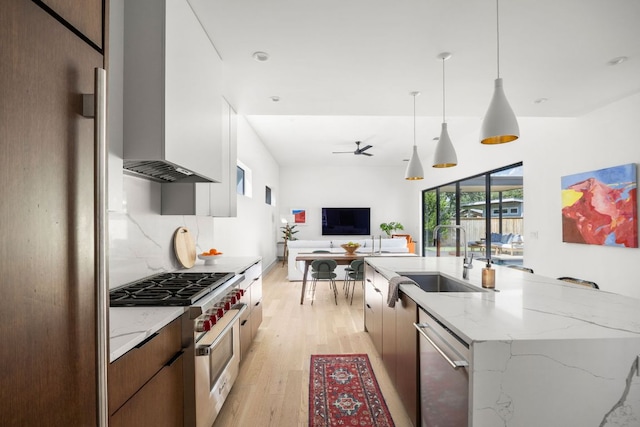 1911 Piedmont Ave, Austin, TX 78757 - kitchen featuring appliances with stainless steel finishes, light wood-style floors, modern cabinets, an island with sink, and open floor plan