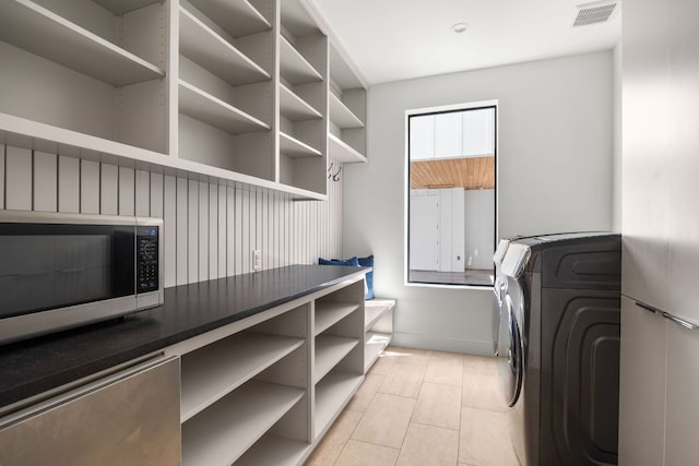 1911 Piedmont Ave, Austin, TX 78757 - laundry room featuring washer / clothes dryer and light tile patterned flooring