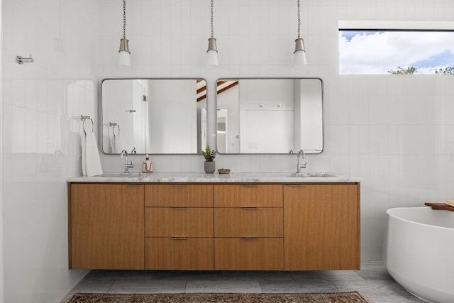 1911 Piedmont Ave, Austin, TX 78757 - full bathroom with tile walls, double vanity, and a soaking tub