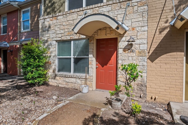 1101 Grove Blvd Unit 206, Austin, TX 78741 - doorway to property featuring stone siding