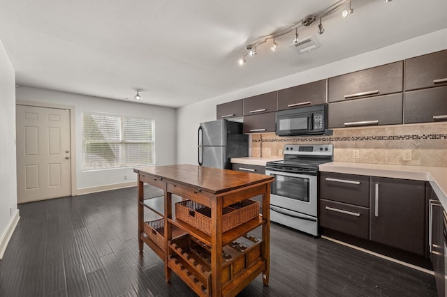 1101 Grove Blvd Unit 206, Austin, TX 78741 - kitchen with stainless steel appliances, light countertops, tasteful backsplash, and dark wood-type flooring