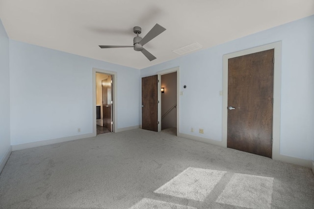 1101 Grove Blvd Unit 206, Austin, TX 78741 - unfurnished bedroom featuring carpet flooring, connected bathroom, and ceiling fan
