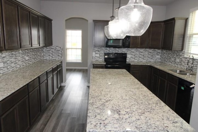 861 Stockdale Rd, Copperas Cove, TX 76522 - kitchen with black appliances, healthy amount of natural light, arched walkways, and dark wood finished floors