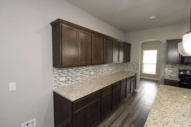 861 Stockdale Rd, Copperas Cove, TX 76522 - kitchen featuring arched walkways, black range with electric cooktop, dark wood finished floors, tasteful backsplash, and dark brown cabinetry