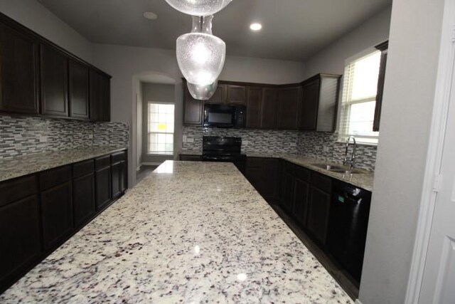 861 Stockdale Rd, Copperas Cove, TX 76522 - kitchen with black appliances, light stone counters, tasteful backsplash, and recessed lighting
