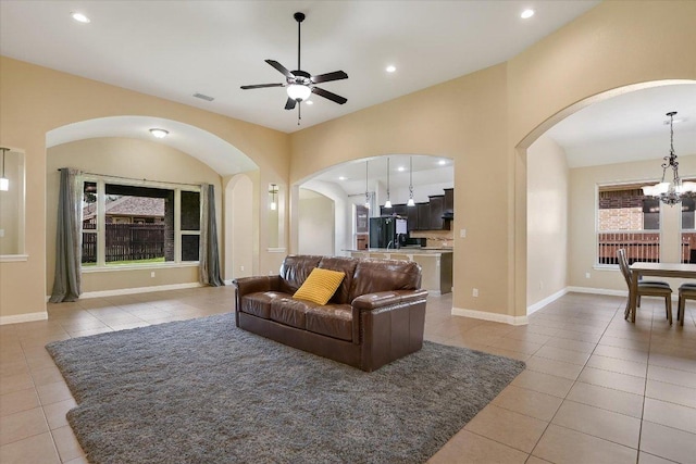 2944 Saint Federico Way, Round Rock, TX 78665 - living room with arched walkways, light tile patterned floors, a chandelier, ceiling fan, and recessed lighting