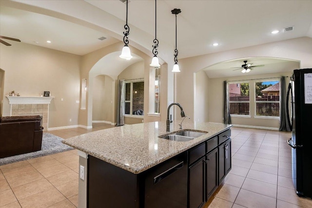 2944 Saint Federico Way, Round Rock, TX 78665 - kitchen featuring a ceiling fan, open floor plan, arched walkways, light tile patterned floors, and recessed lighting
