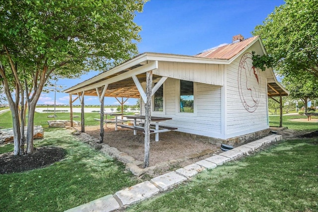2944 Saint Federico Way, Round Rock, TX 78665 - view of property exterior with a metal roof, a lawn, and a chimney