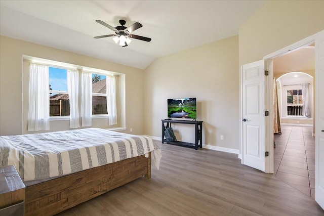 2944 Saint Federico Way, Round Rock, TX 78665 - bedroom with arched walkways, wood finished floors, vaulted ceiling, and ceiling fan