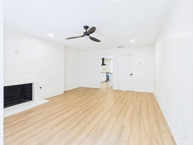6108 Shadow Valley Dr Unit A, Austin, TX 78731 - unfurnished living room with light wood finished floors, ceiling fan, a fireplace, and recessed lighting