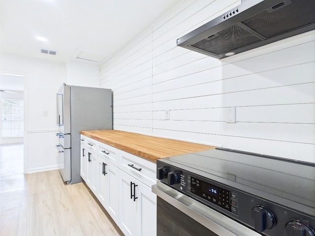 6108 Shadow Valley Dr Unit A, Austin, TX 78731 - kitchen with ventilation hood, range with electric cooktop, freestanding refrigerator, butcher block counters, and light wood-style flooring