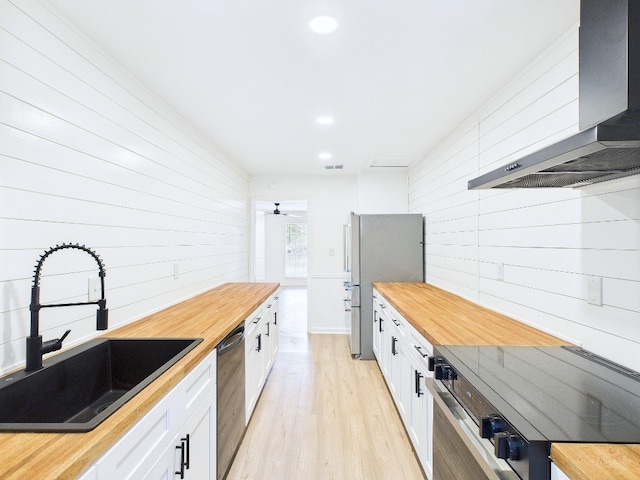 6108 Shadow Valley Dr Unit A, Austin, TX 78731 - kitchen with butcher block countertops, range hood, stainless steel appliances, light wood-style flooring, and recessed lighting