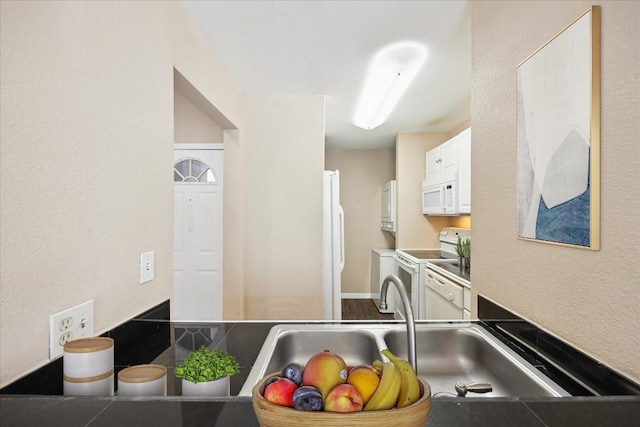 712 W 21st St Unit 202, Austin, TX 78705 - kitchen with white appliances, white cabinets, and a textured wall