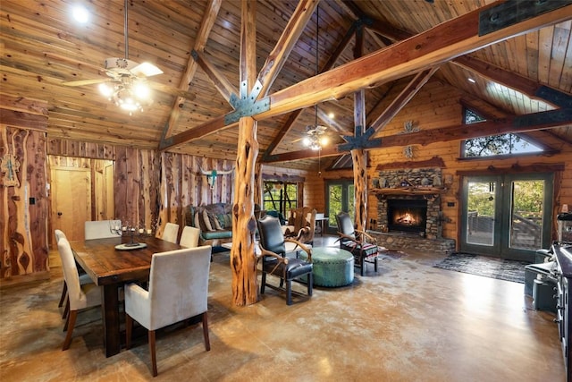 101 Rolling Hills Rd, Blanco, TX 78606 - dining room featuring ceiling fan, wooden walls, concrete flooring, a wood ceiling with exposed beams, and high vaulted ceiling