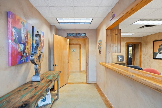 101 Rolling Hills Rd, Blanco, TX 78606 - corridor with a paneled ceiling and light tile patterned flooring