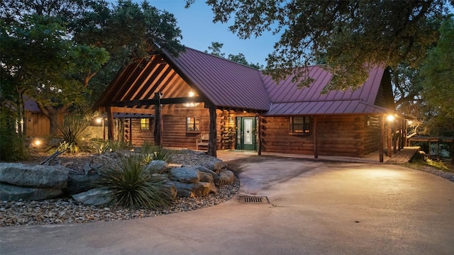 101 Rolling Hills Rd, Blanco, TX 78606 - log-style house featuring a standing seam roof, a metal roof, log siding, and concrete driveway