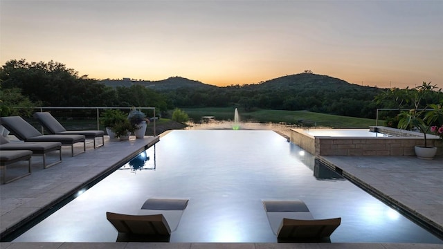 101 Rolling Hills Rd, Blanco, TX 78606 - view of swimming pool featuring an infinity pool, a patio, and a mountain view