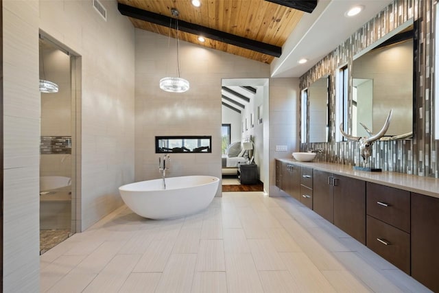 101 Rolling Hills Rd, Blanco, TX 78606 - full bath with tile walls, a freestanding bath, double vanity, wood ceiling, and tiled shower