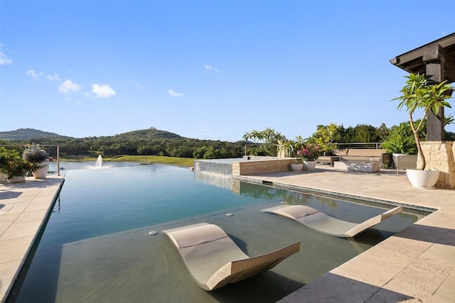 101 Rolling Hills Rd, Blanco, TX 78606 - view of swimming pool with a water view, a patio, and an infinity pool