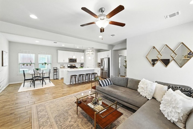 5512 Baythorne Dr, Austin, TX 78747 - living area featuring light wood finished floors, ceiling fan, and recessed lighting