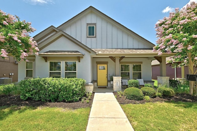 5512 Baythorne Dr, Austin, TX 78747 - view of front of property featuring board and batten siding, a porch, a front yard, and stucco siding