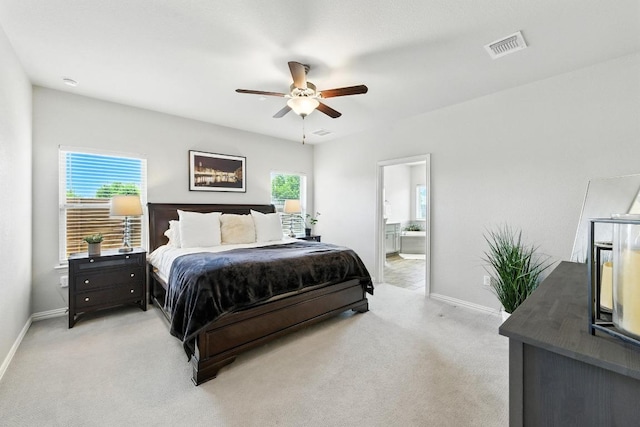 5512 Baythorne Dr, Austin, TX 78747 - bedroom with light carpet, ensuite bath, and ceiling fan