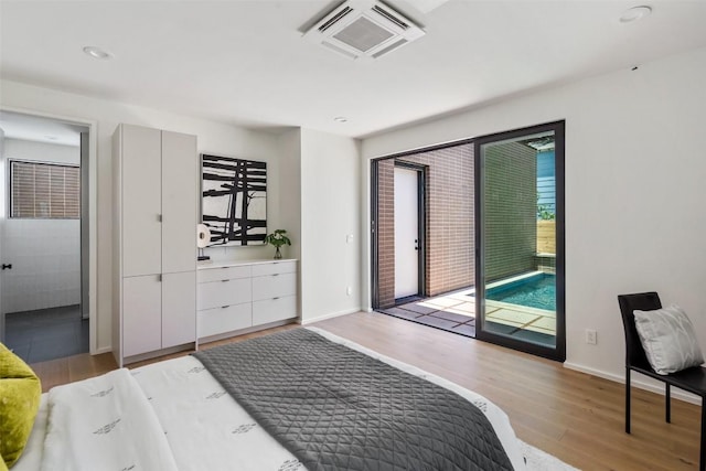 1203 Richcreek Rd, Austin, TX 78757 - bedroom with access to outside, light wood-style flooring, and recessed lighting