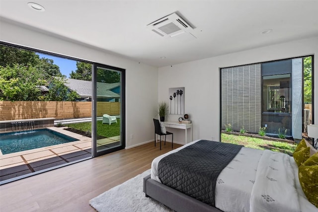 1203 Richcreek Rd, Austin, TX 78757 - bedroom featuring wood finished floors, access to exterior, and recessed lighting