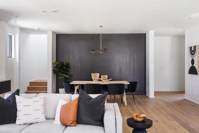 1203 Richcreek Rd, Austin, TX 78757 - living area with light wood-style flooring, an accent wall, and stairway
