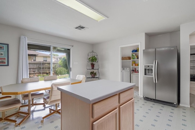 2010 Hawksbury Way, Cedar Park, TX 78613 - kitchen featuring stainless steel fridge with ice dispenser, light flooring, light brown cabinets, washer and dryer, and a kitchen island