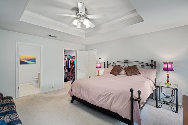 2010 Hawksbury Way, Cedar Park, TX 78613 - bedroom with a tray ceiling, light colored carpet, ornamental molding, a walk in closet, and a closet