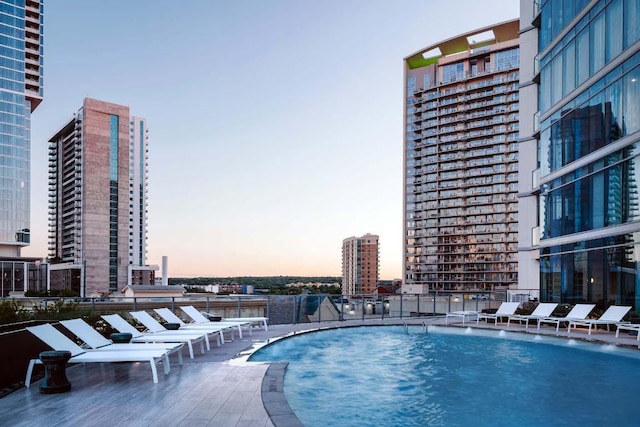 501 W Ave Unit 3201, Austin, TX 78701 - pool at dusk featuring a community pool and a view of city