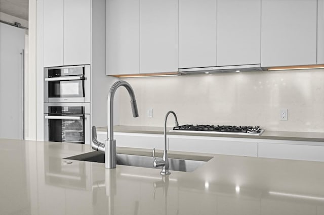 501 W Ave Unit 3201, Austin, TX 78701 - kitchen featuring white cabinetry, gas cooktop, modern cabinets, double oven, and light countertops