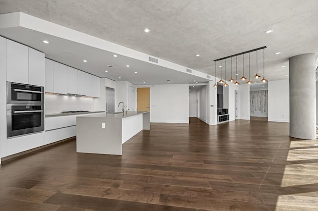 501 W Ave Unit 3201, Austin, TX 78701 - kitchen featuring modern cabinets, open floor plan, double oven, dark wood finished floors, and recessed lighting